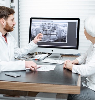 Dentist showing a patient what the problem might be