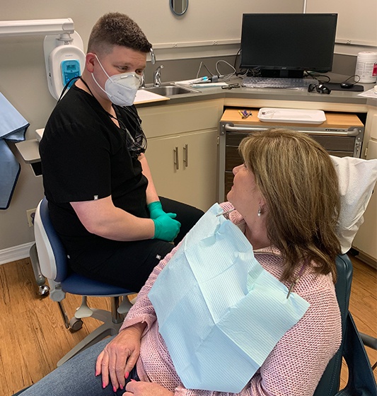 Dentist talking to dental patient