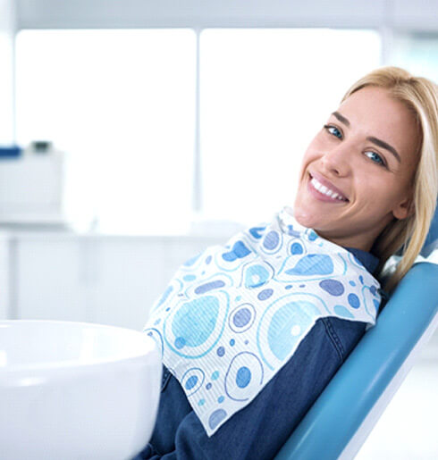 Smiling woman in dentist’s chair