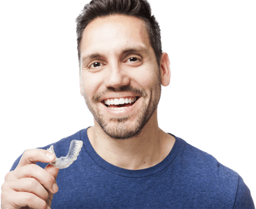smiling man holding clearaligner