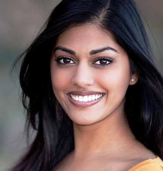 Woman sharing bright smile after professional teeth whitening