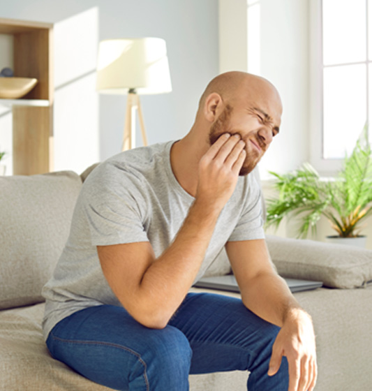 An unhappy man suffering from a toothache