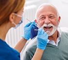 Man smiles at dentist