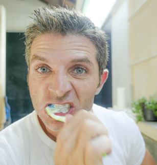 Man brushes teeth
