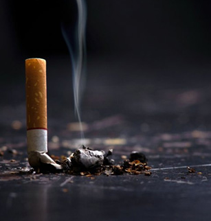 Snuffed cigarette still smolders