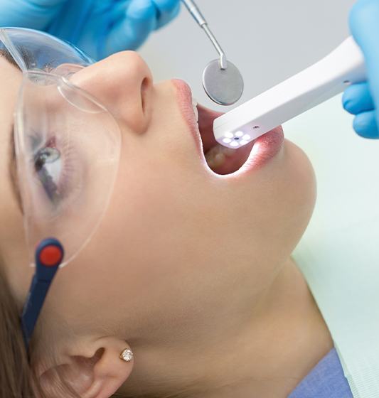 Dentist performing oral cancer screening