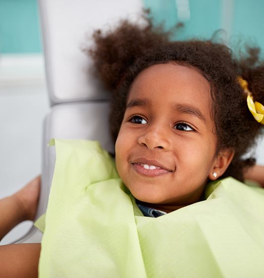 Young girl smiling during children's dentistry visit