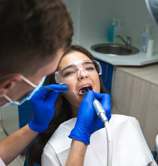 Woman in dental chair undergoing procedure