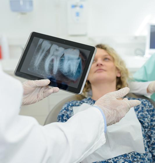 Dentist examining digital x-rays