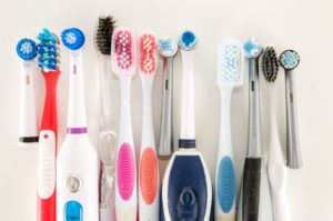 Closeup of an assortment of both manual and electric toothbrushes